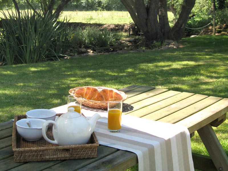 Prendre son petit-déjeuner dans le jardin du gîte © Gite Les 3 Voiles
